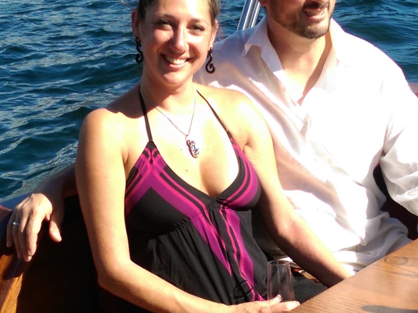 a woman sitting on a boat in the water