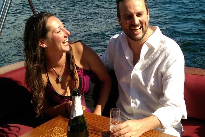 a group of people sitting on a boat in the water