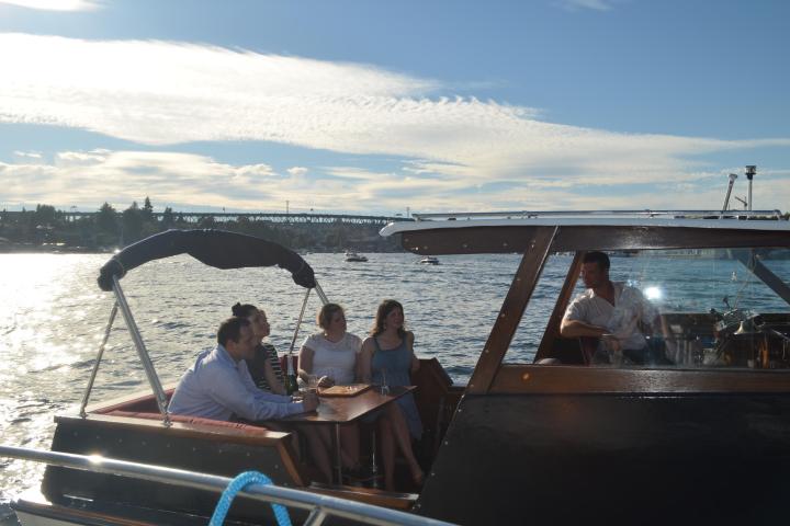 a group of people sitting in a boat on a body of water
